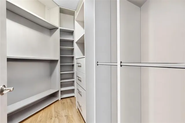 a spacious bathroom with a granite countertop bathtub a sink and a large mirror