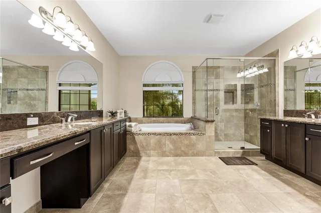 a spacious bathroom with a tub sink and mirror