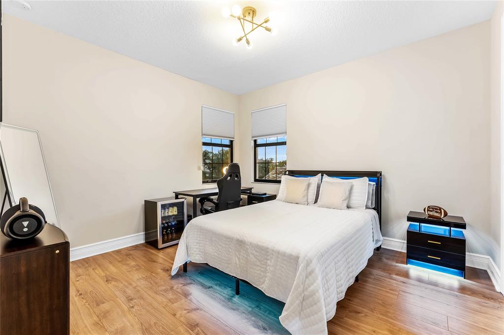 9571 Eden Roc Court Delray Beach, FL 33446 - Photo 32 of 45 a bedroom with a bed a table and chair