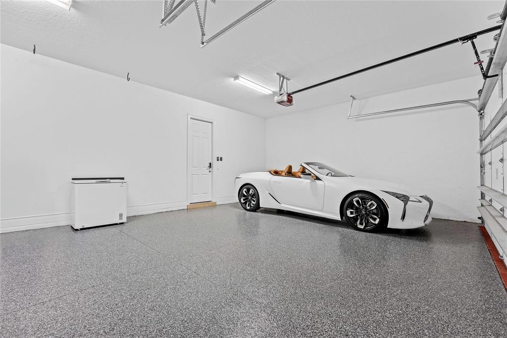 9571 Eden Roc Court Delray Beach, FL 33446 - Photo 35 of 45 a car parked in a garage