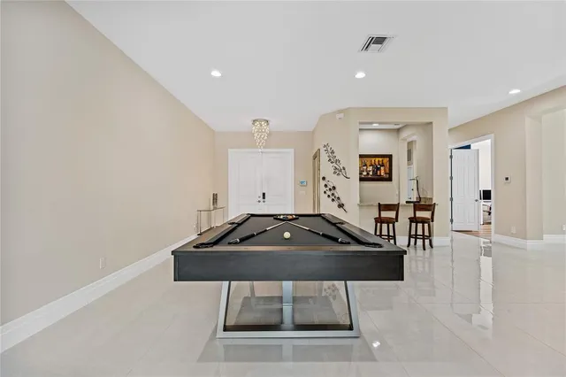 a bathroom with a granite countertop sink a toilet a mirror and a window