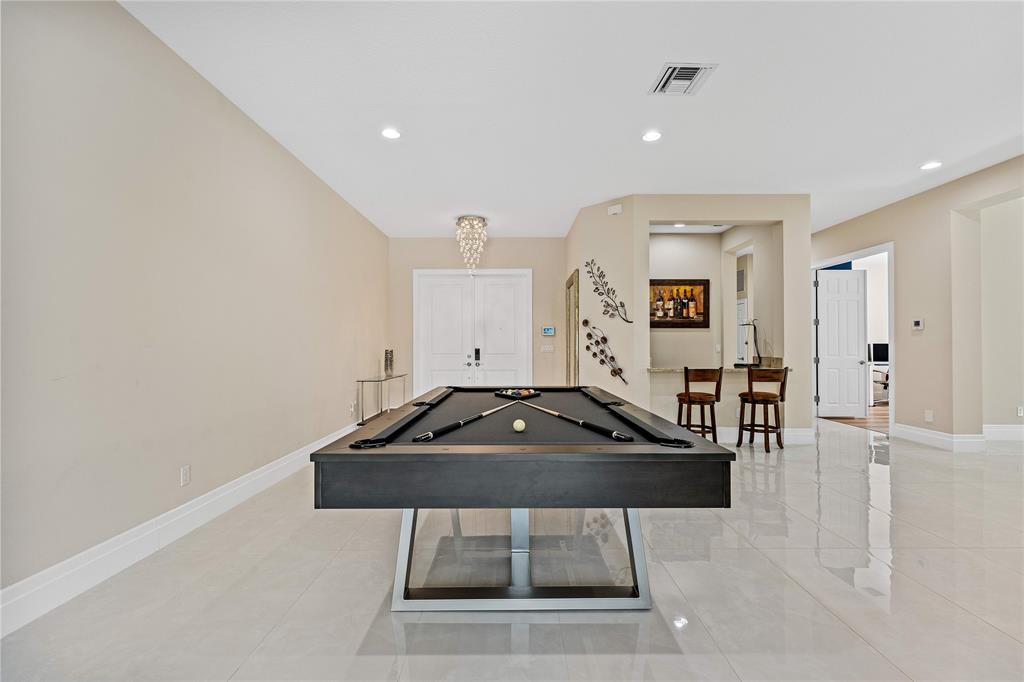 9571 Eden Roc Court Delray Beach, FL 33446 - Photo 4 of 45 a room with furniture and a table