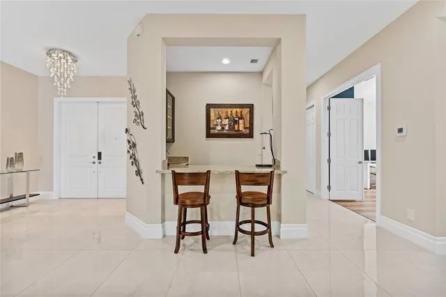 a view of a dining room with furniture and a chandelier