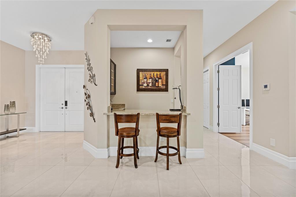 9571 Eden Roc Court Delray Beach, FL 33446 - Photo 5 of 45 a view of a hallway with seating area