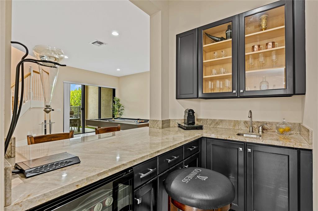 9571 Eden Roc Court Delray Beach, FL 33446 - Photo 6 of 45 a bathroom with a granite countertop sink a toilet a mirror and a window