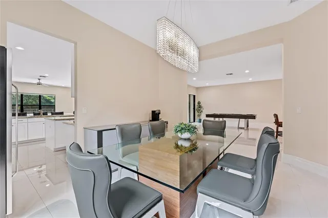 a large white kitchen with granite countertop a large window and stainless steel appliances
