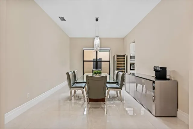 a kitchen with granite countertop white cabinets and stainless steel appliances