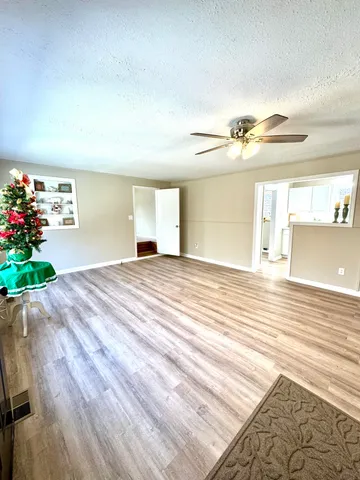 a view of an empty room and wooden floor