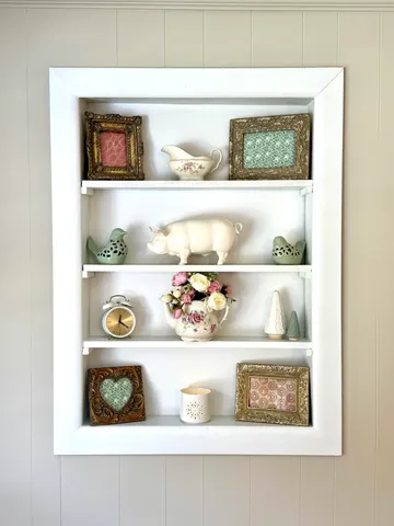 a shelf with cup and plates