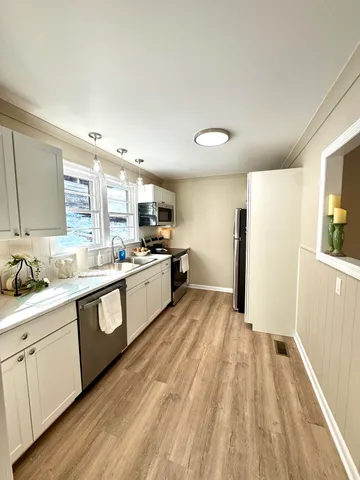 a large kitchen with a lot of counter space and appliances