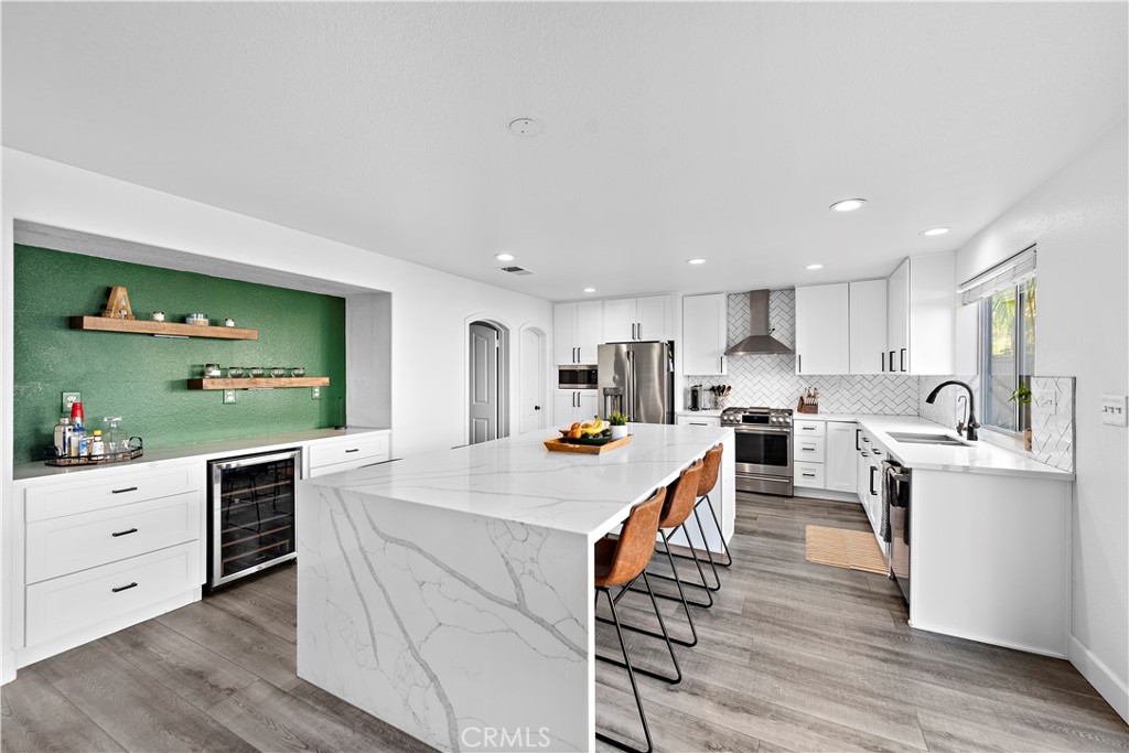 a large kitchen with kitchen island a island in the center