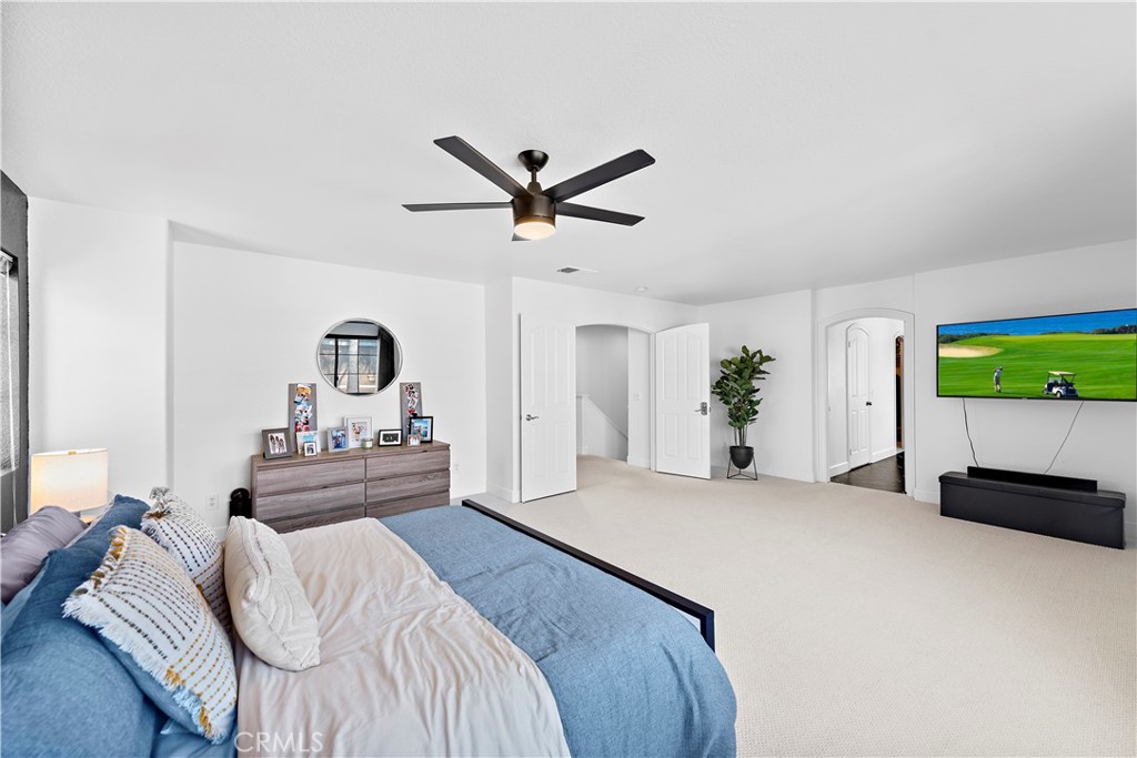 4314 Silver Spring Way Oceanside, CA 92057 - Photo 19 of 49 a bedroom with a bed and a chandelier