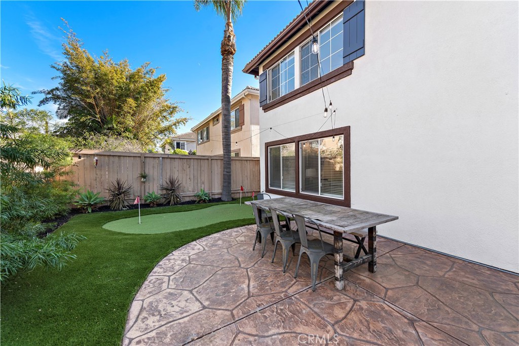 4314 Silver Spring Way Oceanside, CA 92057 - Photo 27 of 49 a backyard of a house with table and chairs