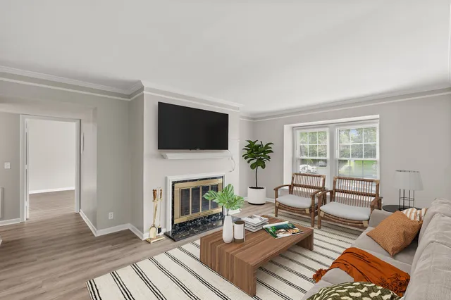 a living room with furniture a fireplace and a flat screen tv