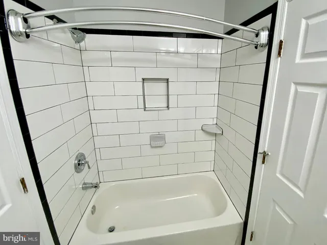 a bathroom with a shower and a bath tub