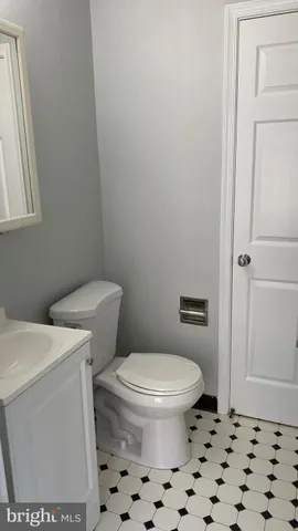 a white toilet sitting next to a shower curtain