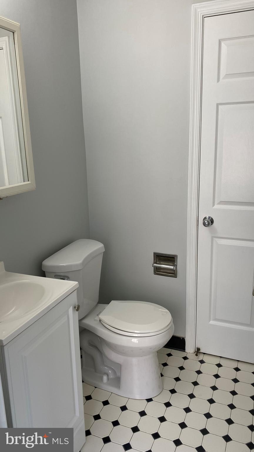 4733 Bradley Boulevard, Unit 11 Chevy Chase, MD 20815 - Photo 7 of 10 a white toilet sitting next to a shower curtain