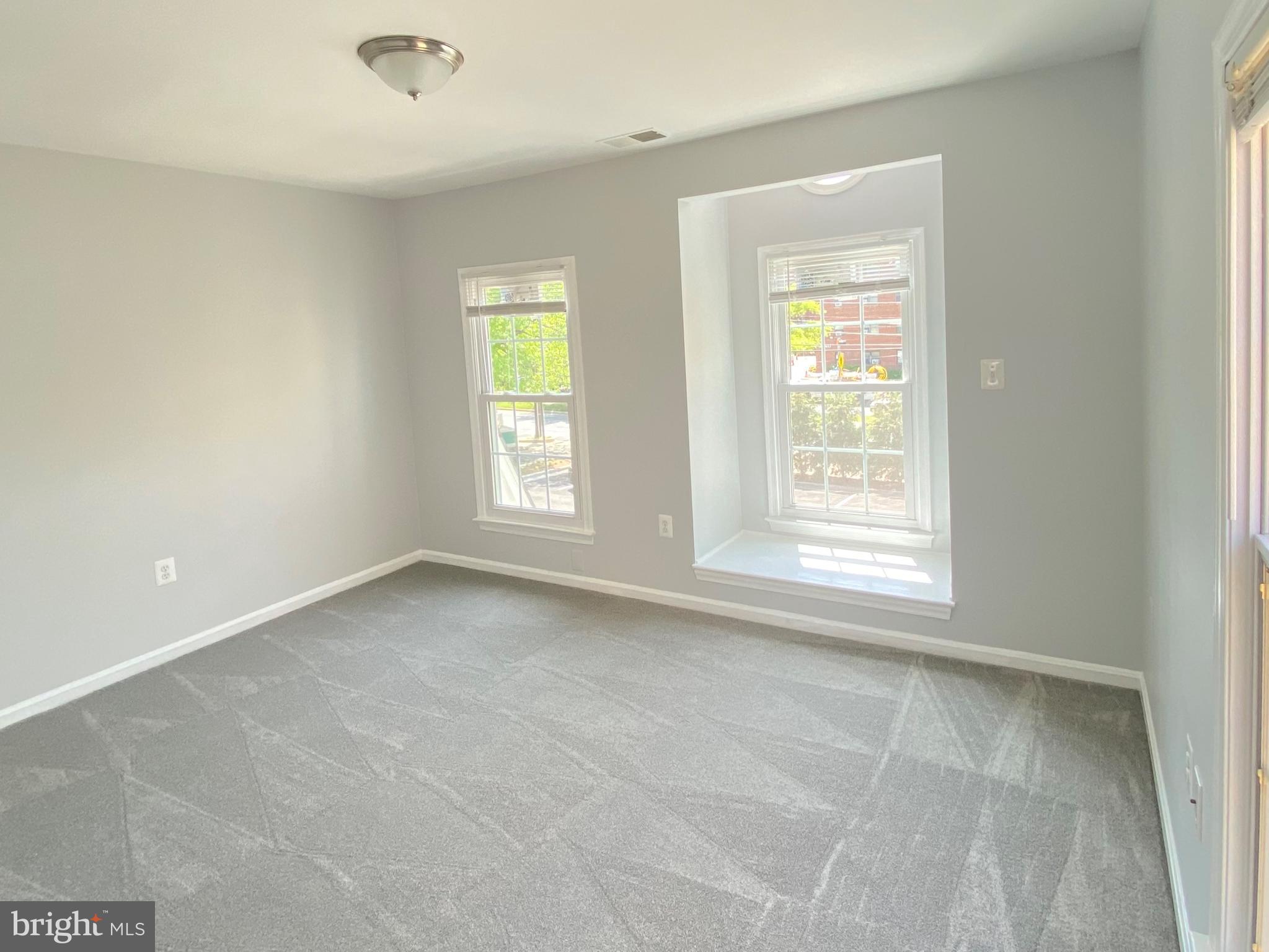 4733 Bradley Boulevard, Unit 11 Chevy Chase, MD 20815 - Photo 8 of 10 an empty room with a window