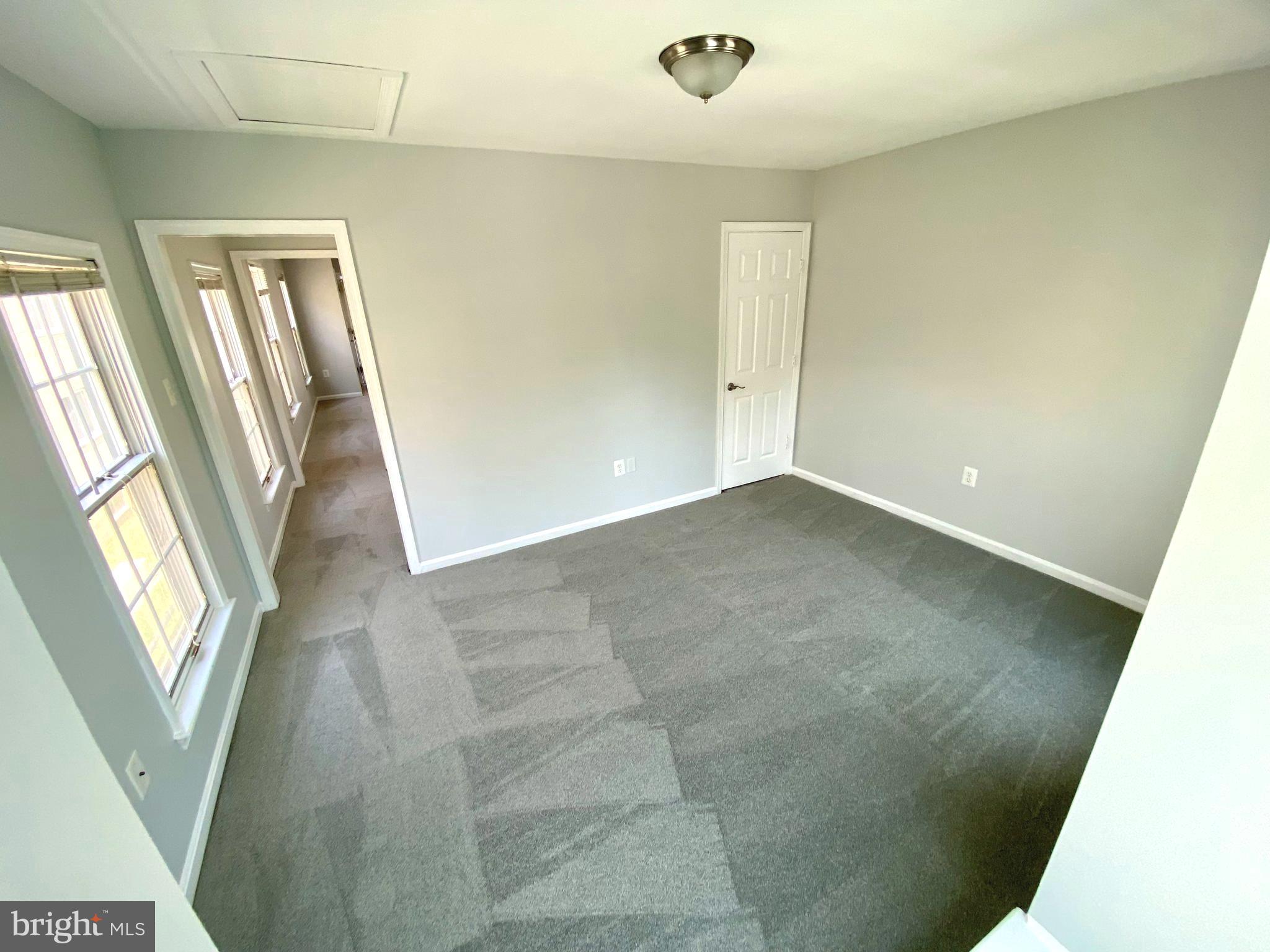 4733 Bradley Boulevard, Unit 11 Chevy Chase, MD 20815 - Photo 9 of 10 a view of an empty room with a window