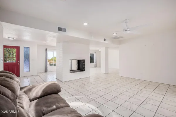 a kitchen with granite countertop a sink stainless steel appliances and white cabinets