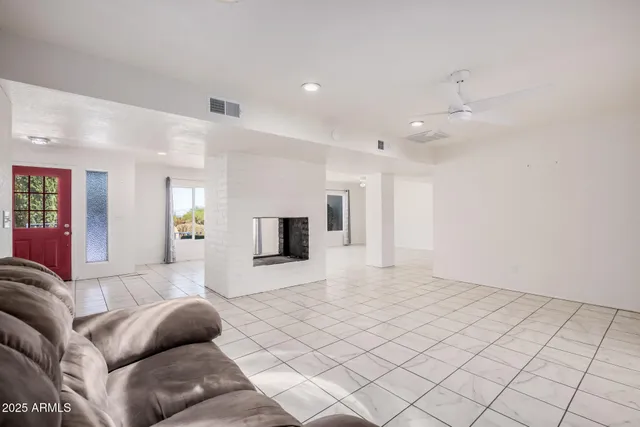 a kitchen with granite countertop a sink stainless steel appliances and white cabinets