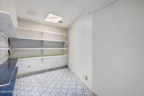 an empty room with windows and cabinet