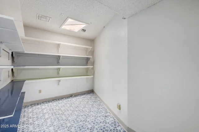 an empty room with windows and cabinet