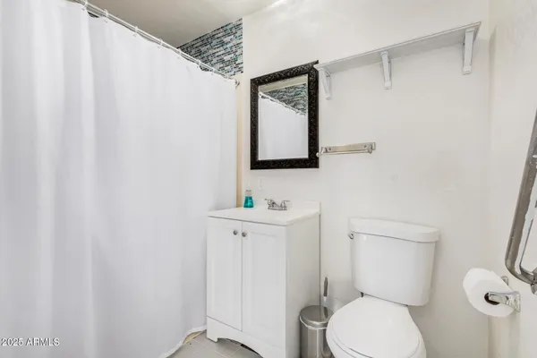 a bathroom with a sink a mirror and a shower