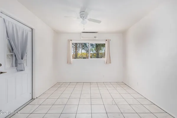 a kitchen with white cabinets and appliances