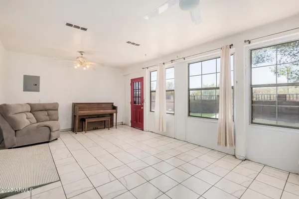 a view of a house with backyard and trees