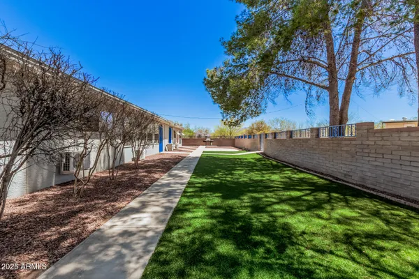 a view of a porch with furniture and a yard