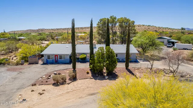 a view of a terrace with a table and chairs under an umbrella