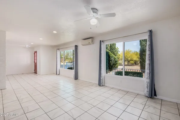 a living room with furniture a rug and a large window