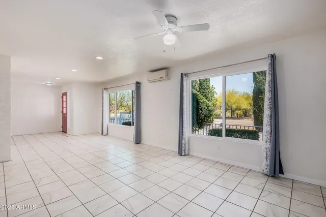 a living room with furniture a rug and a large window