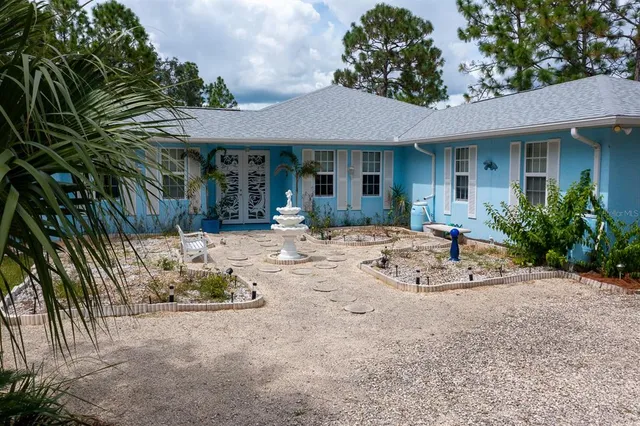 a front view of a house with a yard and trees
