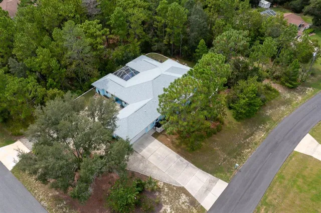 a large white kitchen with stainless steel appliances granite countertop a sink dishwasher stove and cabinets with wooden floor