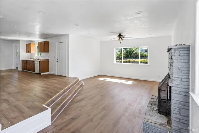 a view of a livingroom with wooden floor and a flat screen tv