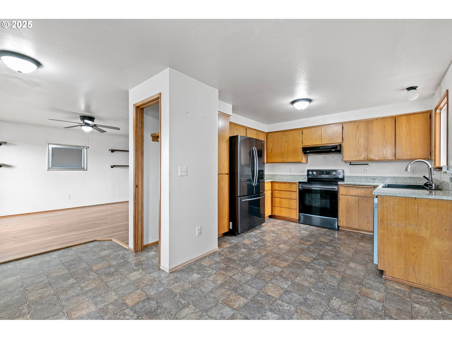 351 South 37th Place Springfield, OR 97478 - Photo 14 of 39 a kitchen with stainless steel appliances granite countertop a refrigerator and a sink