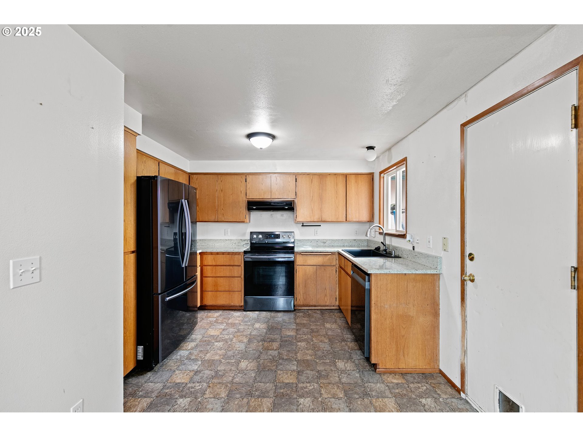 351 South 37th Place Springfield, OR 97478 - Photo 17 of 39 a kitchen with stainless steel appliances granite countertop a refrigerator a sink a stove and a microwave