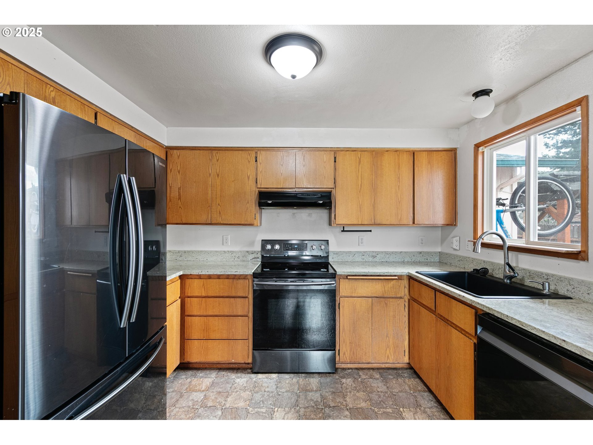 351 South 37th Place Springfield, OR 97478 - Photo 18 of 39 a kitchen with stainless steel appliances granite countertop a stove a refrigerator and a sink
