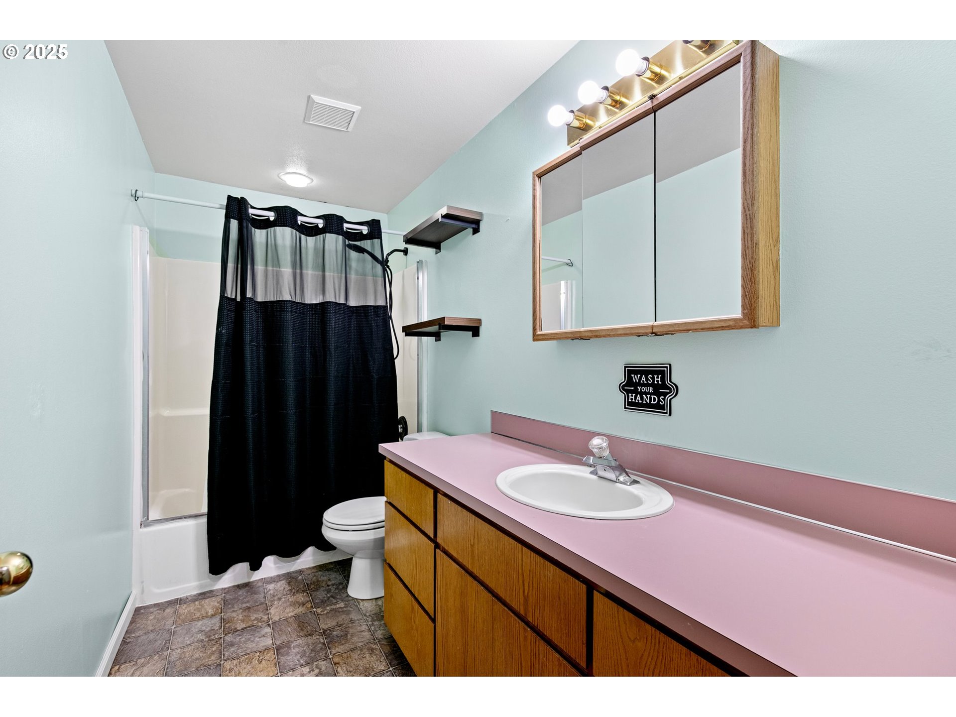 351 South 37th Place Springfield, OR 97478 - Photo 22 of 39 a bathroom with a sink a toilet a mirror and shower