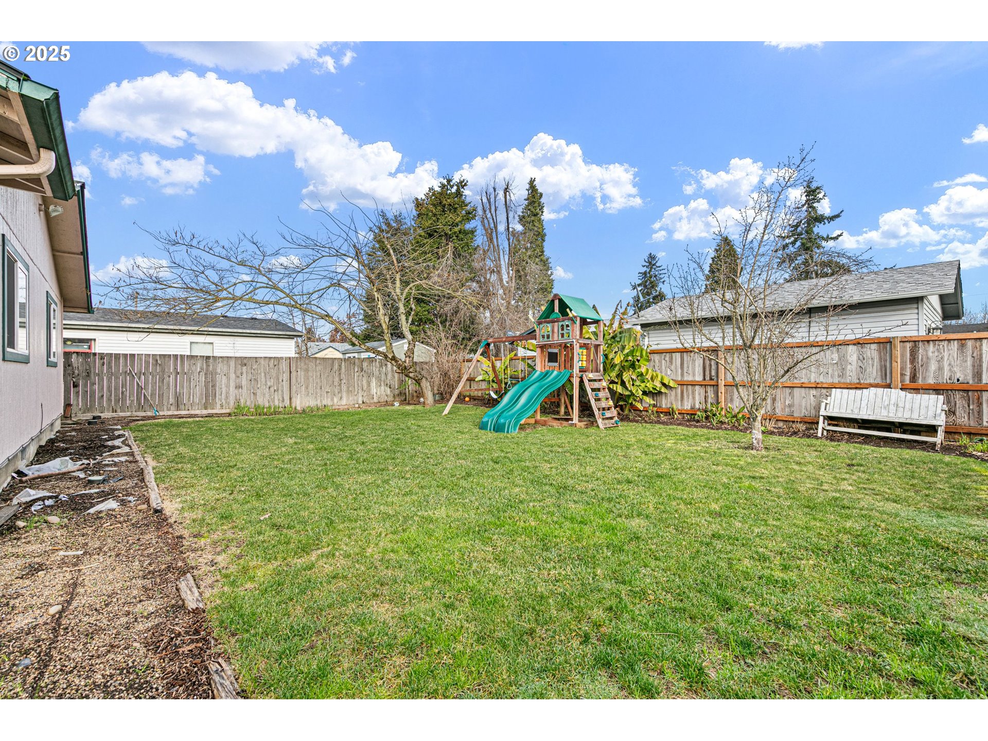 351 South 37th Place Springfield, OR 97478 - Photo 35 of 39 a view of a house with a backyard and a patio