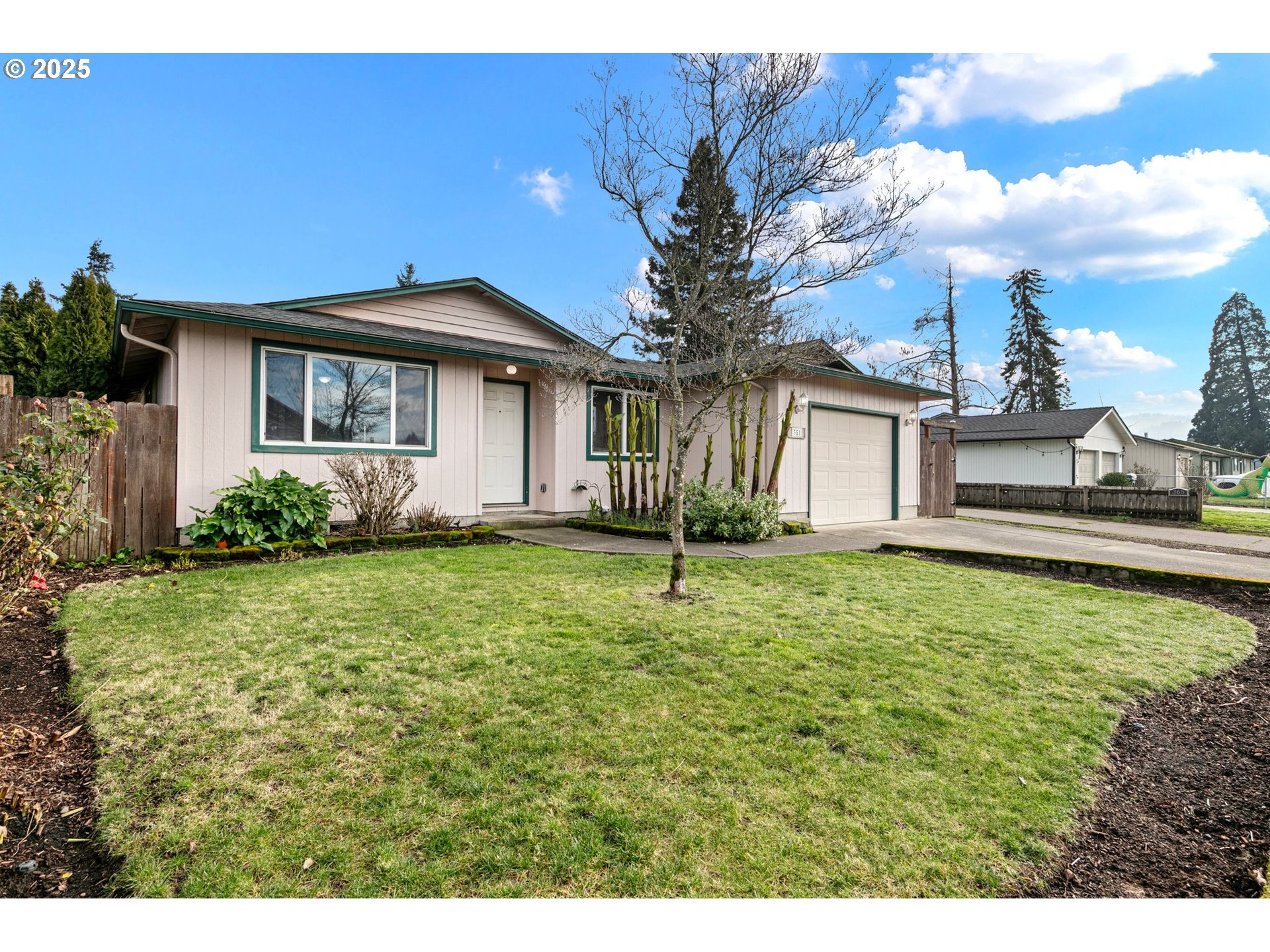 351 South 37th Place Springfield, OR 97478 - Photo 4 of 39 a white house with a big yard and potted plants in front of it