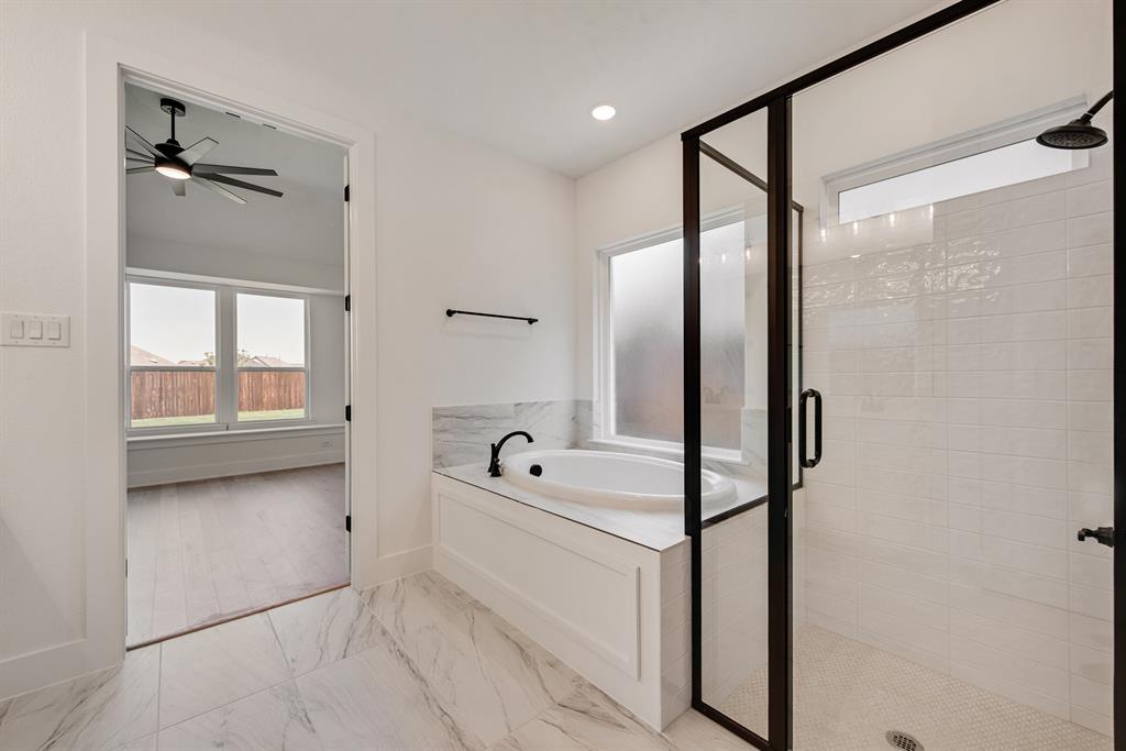 6024 Foxwheel Way Fort Worth, TX 76123 - Photo 14 of 30 a bathroom with a tub sink and mirror