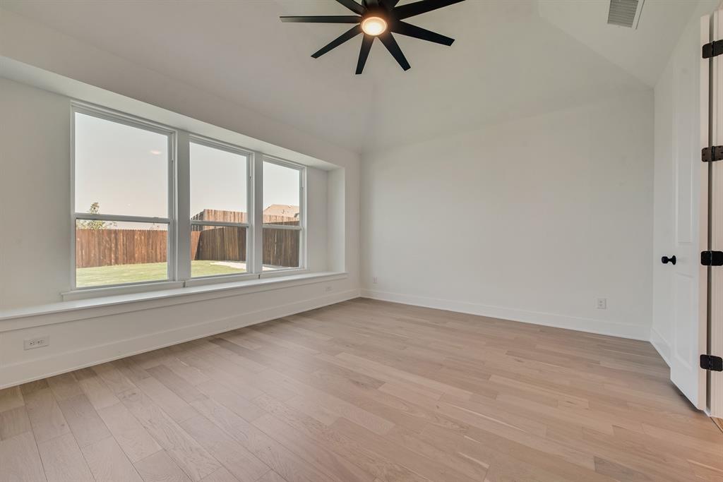 6024 Foxwheel Way Fort Worth, TX 76123 - Photo 16 of 30 a view of an empty room with a window and a ceiling fan