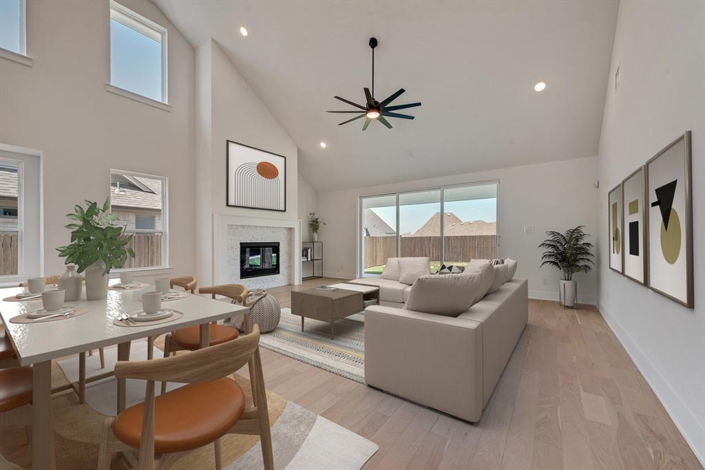 6024 Foxwheel Way Fort Worth, TX 76123 - Photo 26 of 30 a living room with furniture kitchen view and a fireplace