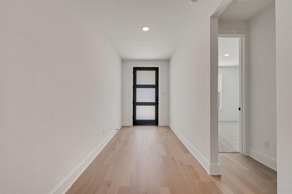 6024 Foxwheel Way Fort Worth, TX 76123 - Photo 3 of 30 wooden floor in a hall with an empty room