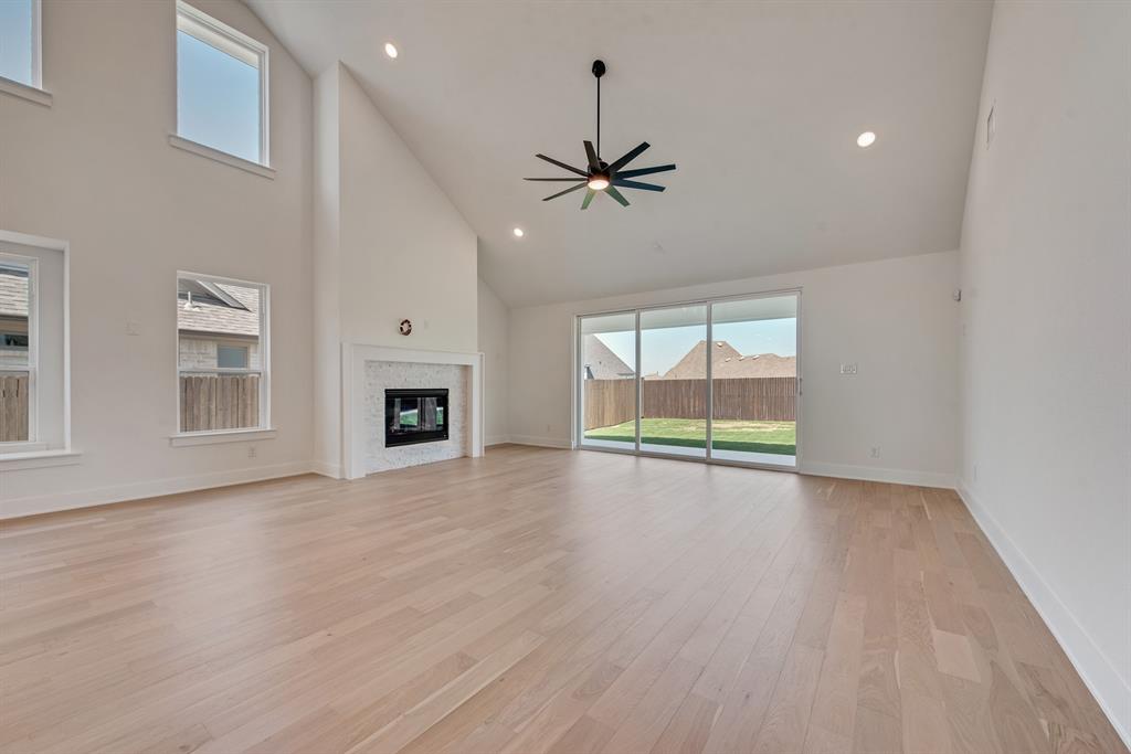 6024 Foxwheel Way Fort Worth, TX 76123 - Photo 4 of 30 a view of an empty room with a window and wooden floor