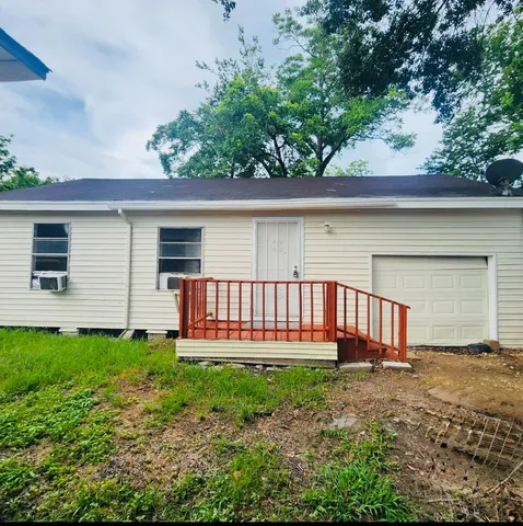 a backyard of a house with a garden and deck