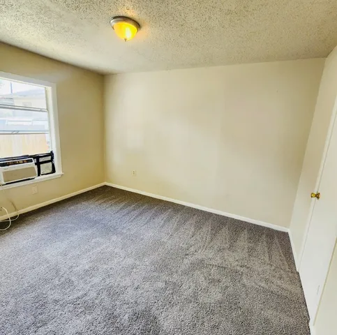 a view of an empty room and a window